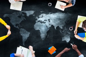 Students studying on a black table with global map on it