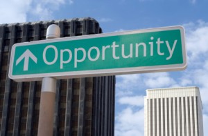 Street sign with an arrow and the word "opportunity" located in a business district.